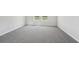 Spacious carpeted bedroom with bright natural light from two windows overlooking the backyard at 3910 Radiant Mountain Dr, Plant City, FL 33565