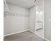 Well-organized walk-in closet leading to a well-lit bathroom with granite countertop at 3910 Radiant Mountain Dr, Plant City, FL 33565