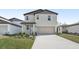 Charming two-story home with manicured lawn, attached two-car garage and light-colored exterior at 3910 Radiant Mountain Dr, Plant City, FL 33565