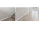 Hallway with neutral tile flooring and stairway with carpeted steps at 3910 Radiant Mountain Dr, Plant City, FL 33565