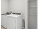 Laundry room featuring modern, front-loading washer and dryer, plus shelving at 3910 Radiant Mountain Dr, Plant City, FL 33565