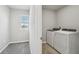 Functional laundry room with modern washer and dryer, ample space, and a bright window at 3910 Radiant Mountain Dr, Plant City, FL 33565