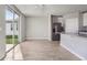 Open-concept living room with tile floors and sliding glass doors to the backyard at 3910 Radiant Mountain Dr, Plant City, FL 33565