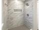 Modern shower with marble tile and rainfall shower head at 1006 Ewing Ave, Clearwater, FL 33756