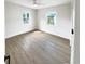 Spacious bedroom with two windows, ceiling fan, and wood-look flooring at 2585 15Th N Ave, St Petersburg, FL 33713