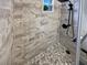Updated bathroom with marble-look tile shower and pebble floor at 2585 15Th N Ave, St Petersburg, FL 33713