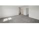 An airy bedroom featuring neutral carpet and a doorway leading to another room at 14033 Crutchfield Ct, Parrish, FL 34219