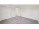 An empty bedroom features neutral gray carpet, white walls, and a large closet with sliding doors at 14033 Crutchfield Ct, Parrish, FL 34219