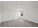 A bedroom with a view from the window and neutral colored carpet at 14033 Crutchfield Ct, Parrish, FL 34219