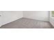 An empty bedroom features neutral gray carpet, white walls, and a window to allow natural light at 14033 Crutchfield Ct, Parrish, FL 34219