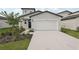 Charming two-story home featuring a light gray exterior, well-maintained landscaping, and a spacious two-car garage at 14033 Crutchfield Ct, Parrish, FL 34219