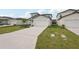 New home boasts a two-car garage, long driveway, and manicured lawn with irrigation at 14033 Crutchfield Ct, Parrish, FL 34219
