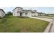 New construction home featuring a well-manicured lawn, two-car garage, and concrete driveway at 14033 Crutchfield Ct, Parrish, FL 34219