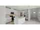 Modern kitchen featuring white cabinets, stainless steel appliances, and a large island with a sink at 14033 Crutchfield Ct, Parrish, FL 34219