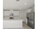 Modern kitchen featuring white cabinets, stainless steel appliances, and a large island perfect for entertaining at 14033 Crutchfield Ct, Parrish, FL 34219