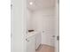 The laundry room contains white machines and a door to the rest of the home at 14033 Crutchfield Ct, Parrish, FL 34219