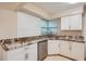 Modern kitchen with white cabinets and granite countertops at 6445 Skyline Ct, Spring Hill, FL 34606