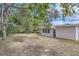 Spacious backyard with mature trees and grassy area at 6445 Skyline Ct, Spring Hill, FL 34606