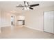 Open living room with tile floors, ceiling fan, and kitchen access at 6445 Skyline Ct, Spring Hill, FL 34606