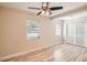 Spacious bedroom with light wood floors and ceiling fan at 6445 Skyline Ct, Spring Hill, FL 34606