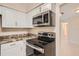 Stainless steel appliances and granite countertops in this kitchen at 6445 Skyline Ct, Spring Hill, FL 34606
