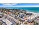 Aerial view showcases a building near the beach with a beautiful ocean view on a bright sunny day at 1129 Seaside Dr # 7, Sarasota, FL 34242