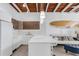Bright kitchen featuring white countertops, breakfast bar, and modern cabinetry at 1129 Seaside Dr # 7, Sarasota, FL 34242