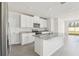 Well-lit kitchen with white cabinets, stainless steel appliances, granite countertops, and tile flooring at 3901 Radiant Mountain Dr, Plant City, FL 33565