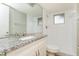 Updated bathroom with granite countertop and shower at 8018 Idle Briar Ln, Port Richey, FL 34668