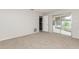 Bedroom with carpet flooring and access to a patio at 8018 Idle Briar Ln, Port Richey, FL 34668