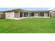 Large backyard with grassy area and screened patio at 8018 Idle Briar Ln, Port Richey, FL 34668