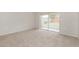Bright Gathering room featuring carpet and sliding glass doors to backyard at 8018 Idle Briar Ln, Port Richey, FL 34668