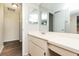 Bathroom with double vanity and updated flooring at 8018 Idle Briar Ln, Port Richey, FL 34668
