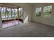 Bedroom featuring a screened-in porch overlooking a scenic lake view, creating a peaceful and inviting space at 23713 Acorn Hill Dr, Lutz, FL 33559