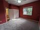 Bedroom with closet and ensuite bathroom offering both functionality and convenience, enhanced by a view of nature at 23713 Acorn Hill Dr, Lutz, FL 33559