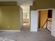 Spacious bedroom with carpeted floors, a walk-in closet, and a view of the stairwell and the ensuite bathroom at 23713 Acorn Hill Dr, Lutz, FL 33559