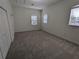 Spacious bedroom featuring lots of natural light, complemented by neutral walls and carpeting for a tranquil ambiance at 23713 Acorn Hill Dr, Lutz, FL 33559