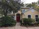 Attractive home with a red door, manicured landscaping, and a walkway at 23713 Acorn Hill Dr, Lutz, FL 33559