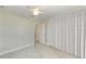 Spacious bedroom with ceiling fan and white curtains at 21475 Meehan Ave, Port Charlotte, FL 33952