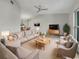 Bright living room with comfortable seating, a large TV, and stylish decor at 18978 Mcgrath Cir, Port Charlotte, FL 33948