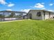 Spacious backyard showcasing lush lawn and pool at 18978 Mcgrath Cir, Port Charlotte, FL 33948