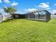 Expansive backyard with grassy lawn and pool area at 18978 Mcgrath Cir, Port Charlotte, FL 33948