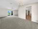 Bright dining room with carpeting and access to the kitchen and living areas at 18978 Mcgrath Cir, Port Charlotte, FL 33948