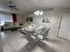 Dining area with glass table and gray chairs, adjacent to living room at 20102 Lorenzo Ave, Port Charlotte, FL 33952