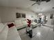 Spacious living room featuring a white sectional sofa and glass coffee table at 20102 Lorenzo Ave, Port Charlotte, FL 33952