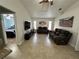 Living room with brown recliner sofa and view into bedroom at 20102 Lorenzo Ave, Port Charlotte, FL 33952