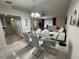 Bright dining area with glass table and gray chairs, near kitchen at 20102 Lorenzo Ave, Port Charlotte, FL 33952
