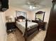 Queen bedroom with dark wood furniture and ceiling fan at 20102 Lorenzo Ave, Port Charlotte, FL 33952