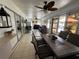 Relaxing screened porch with seating, dining area, and ceiling fan at 20102 Lorenzo Ave, Port Charlotte, FL 33952