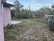 Overgrown backyard with patchy grass at 6114 S 3Rd St, Tampa, FL 33611